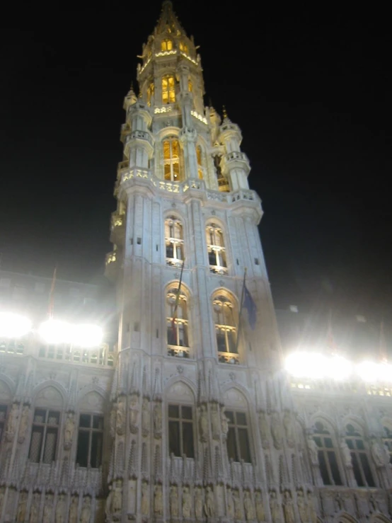 the large building is lit up with light on top