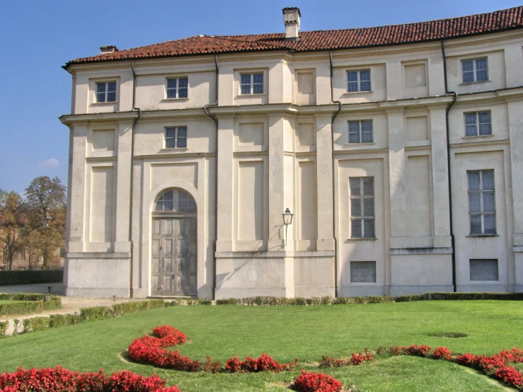 large, architectural house with a lawn in front of it