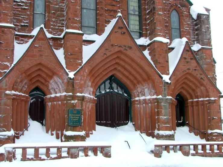 a building in the snow covered by heavy snow