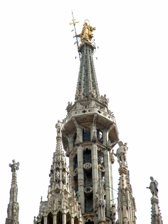 a clock tower with statues on it is pictured