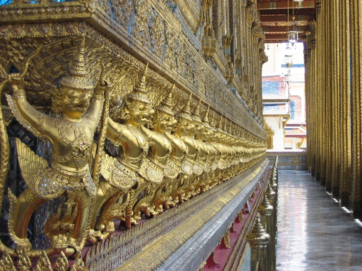 gold garuda and pillars in the golden temple of a buddhist city