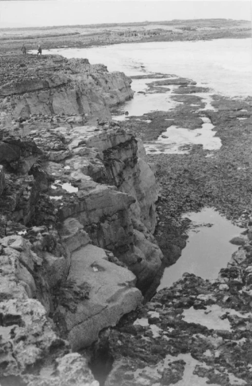 a rocky cliff near some water