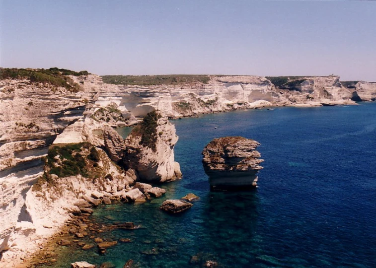 an ocean scene with cliffs and water near one another