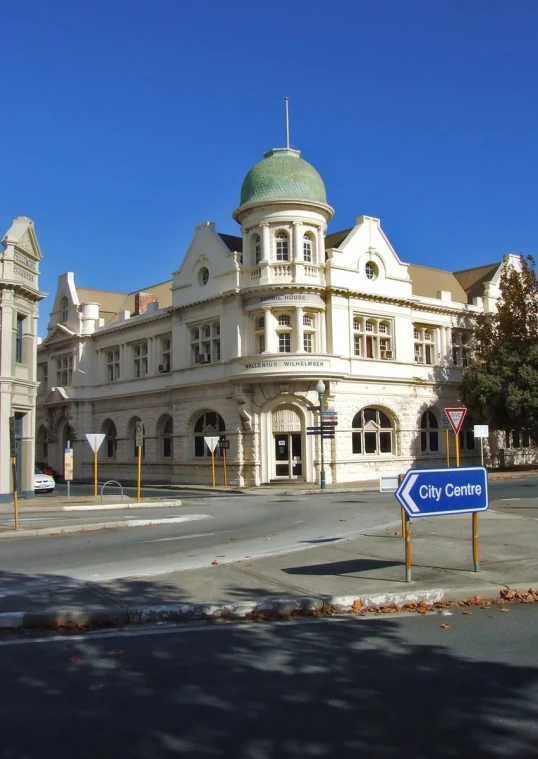 an old style building with a round dome in the middle of a street