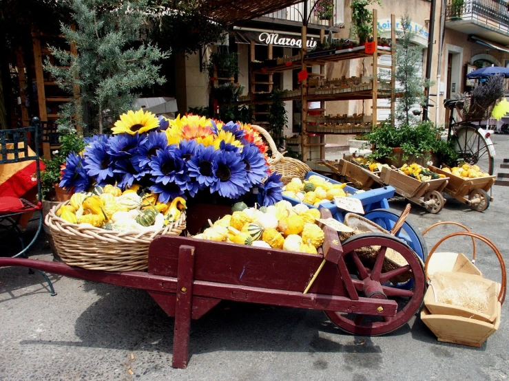 a large wheelbarrow with a bunch of flowers in it
