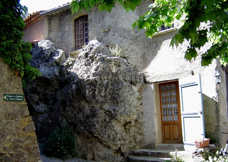 a big boulder outside a small building