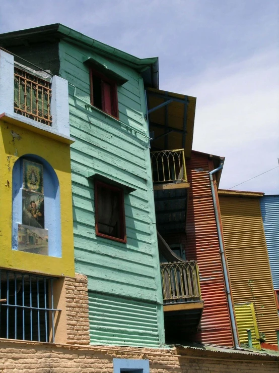 two large multi - colored buildings with red and yellow doors