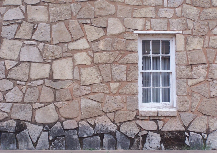 a brick wall with a window in it