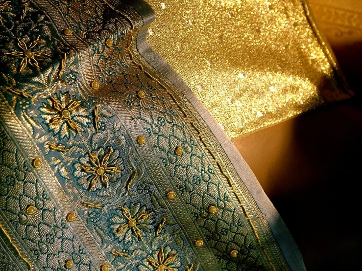 close up view of fabric with gold flower designs