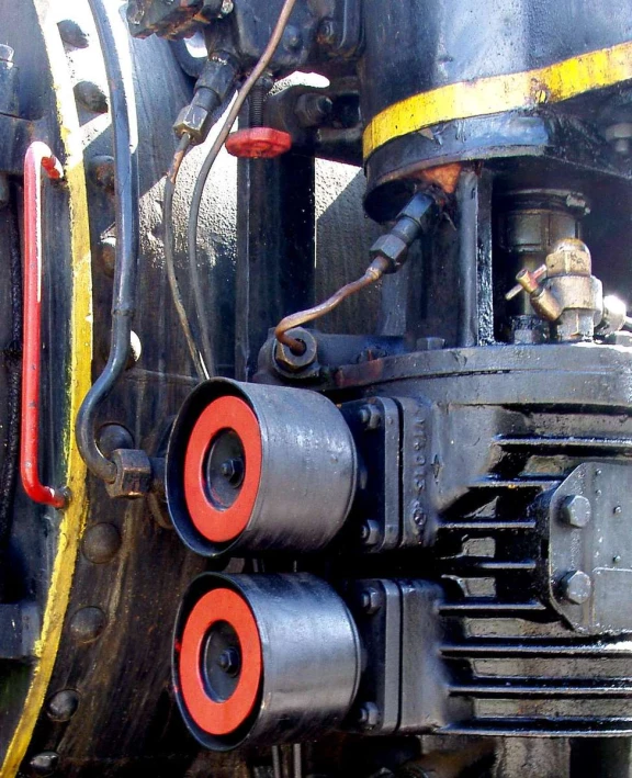 two red metal s sitting on the front of a train