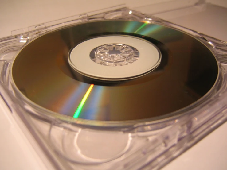 a cd sits on top of a clear package