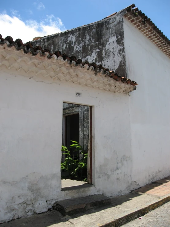 an open door in to a building that is white