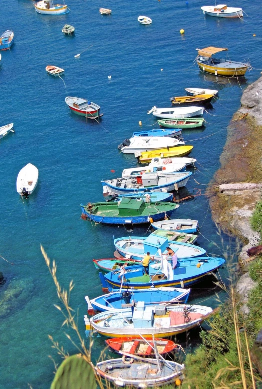 colorful boats are docked at a small harbor