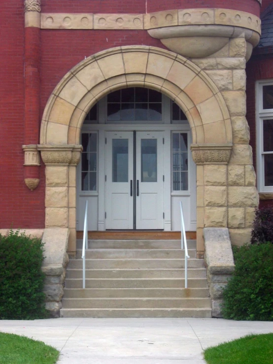 front entrance of red brick building with white double doors