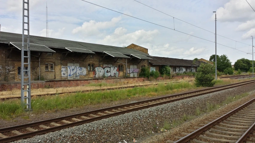 a train yard with train tracks and graffiti