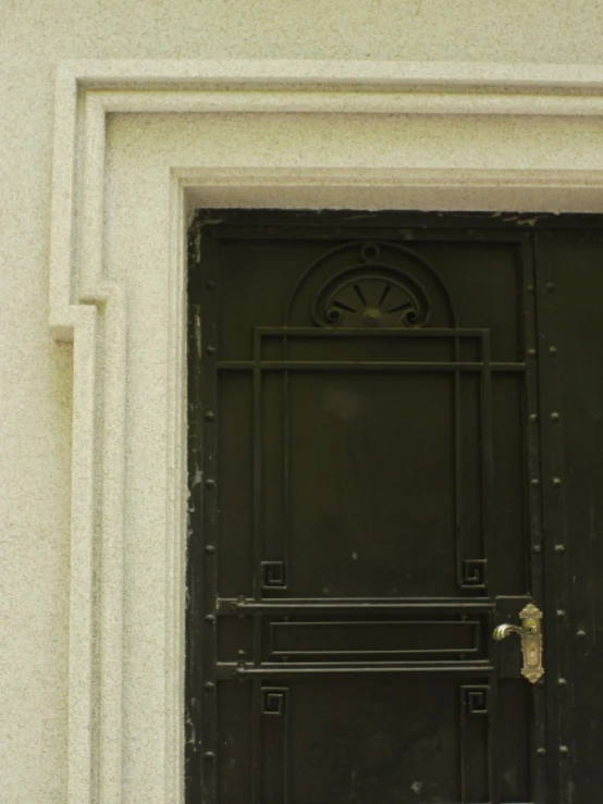 a white stucco building with a black door