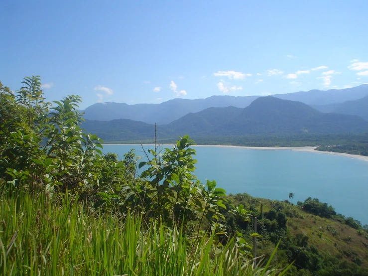 there is a clear blue water surrounded by mountains