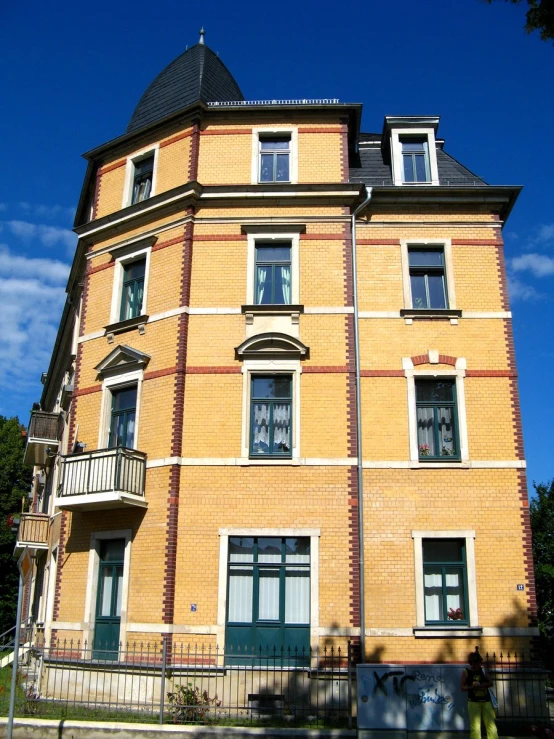 a brick building has many windows and balconies