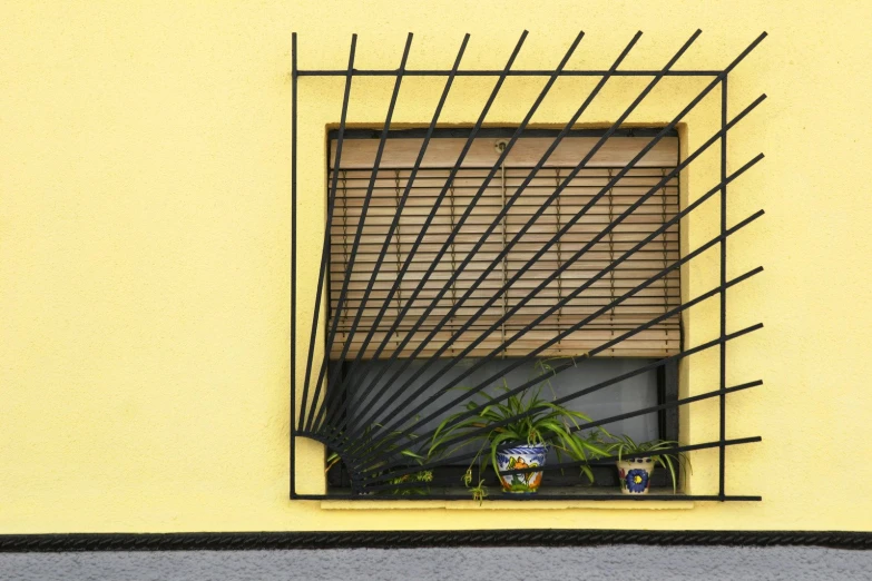 a window with bamboo blinds and plants