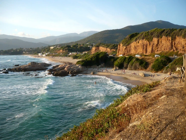 beach with water and mountains in the distance