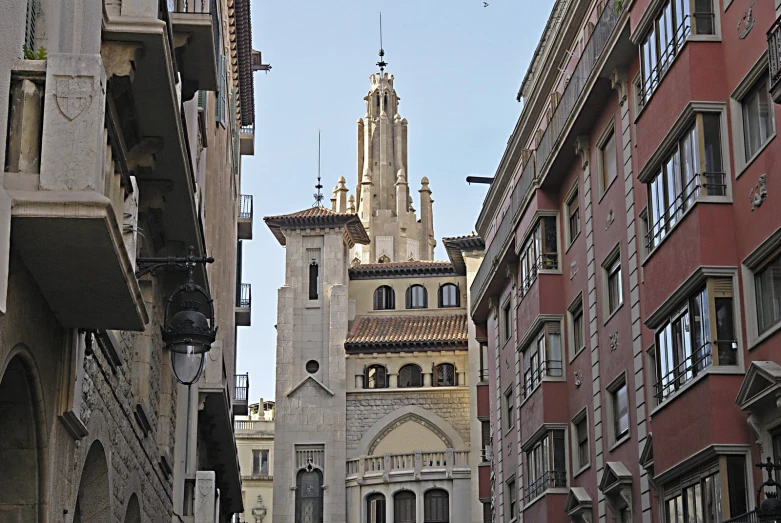a large cathedral next to some buildings with balconies