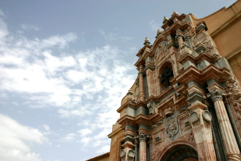 an ornate brick structure on the side of a large building