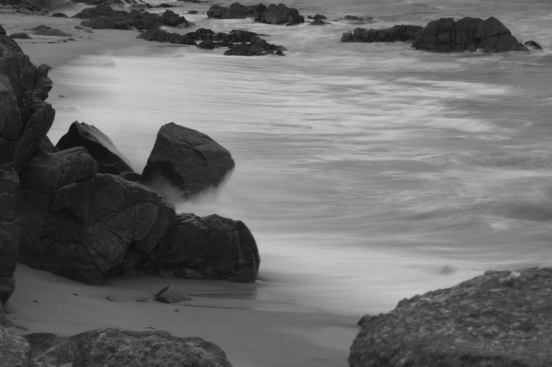 black and white pograph of ocean and rocky shoreline