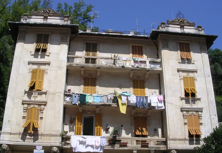 a large white building with yellow clothes hanging on it