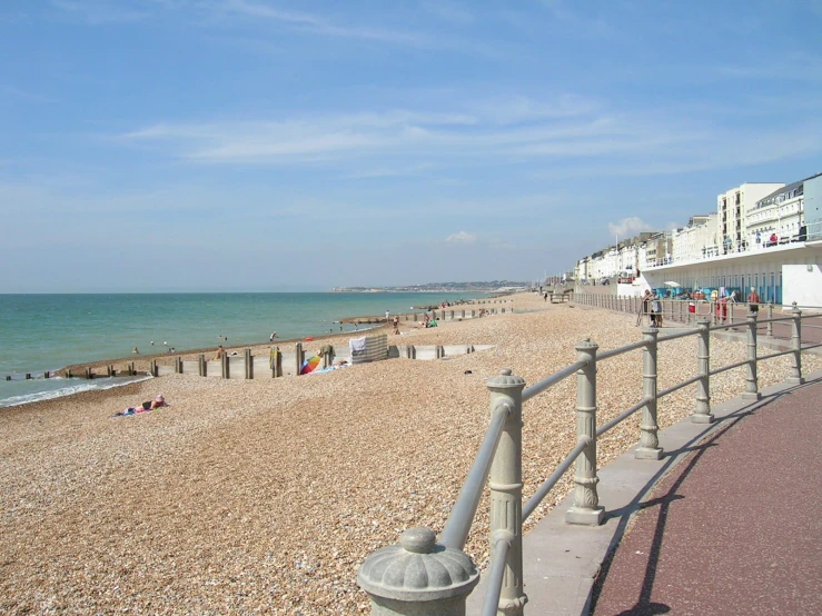 a beach with buildings along it next to the water