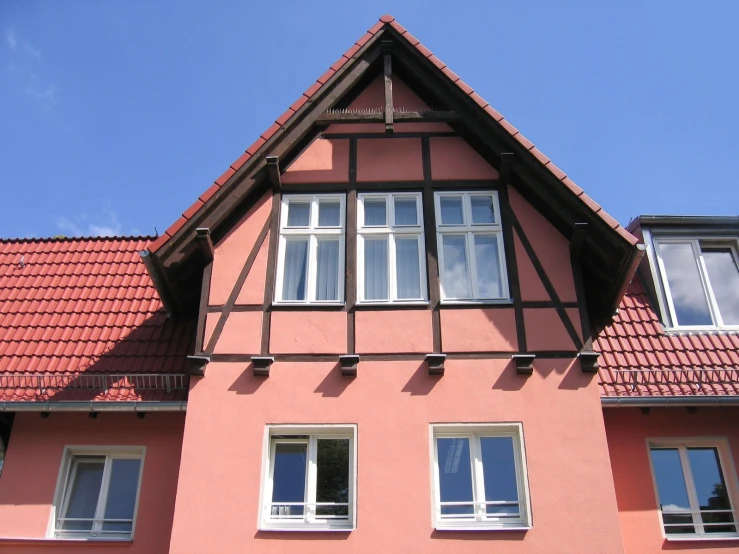 a red building with windows and some sky