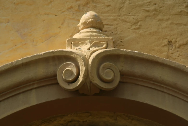 the top of an ornate carving work on a wall