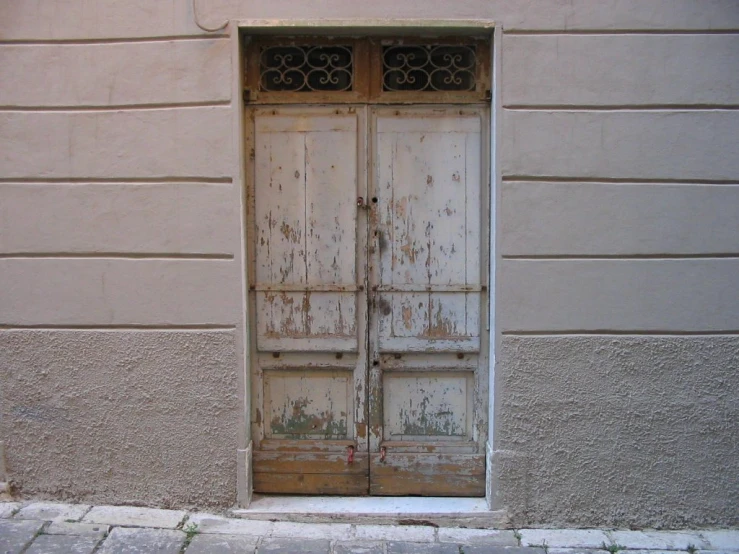 an old wooden door sitting in the middle of a window sill