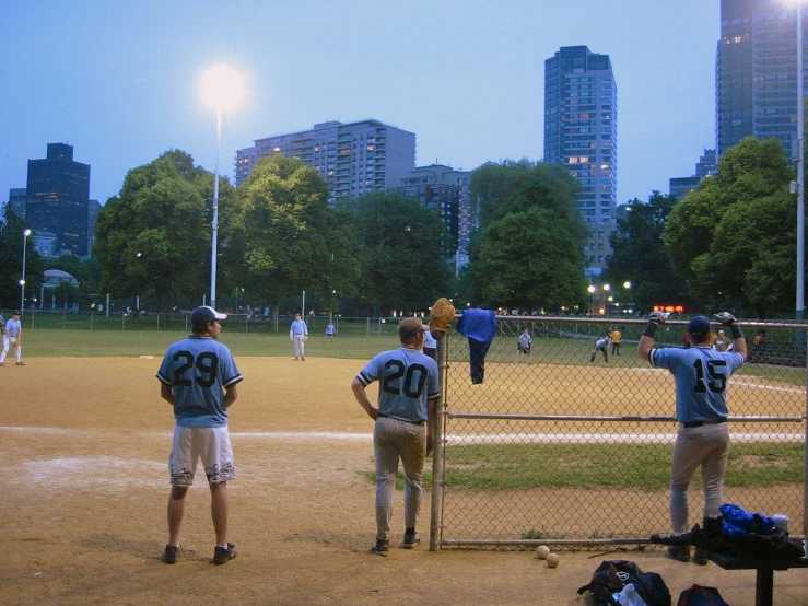 several baseball players waiting for the pitch to be pitched