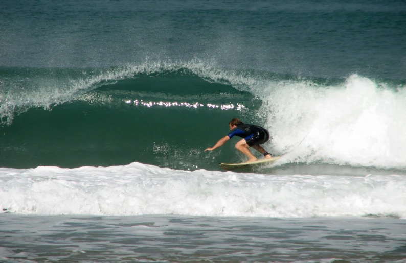 the surfer is surfing on the wave in the ocean