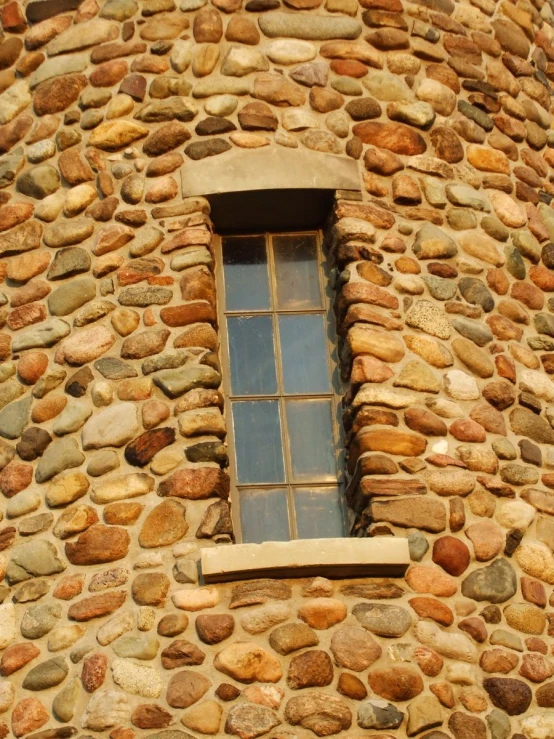 a stone house with a window on the side