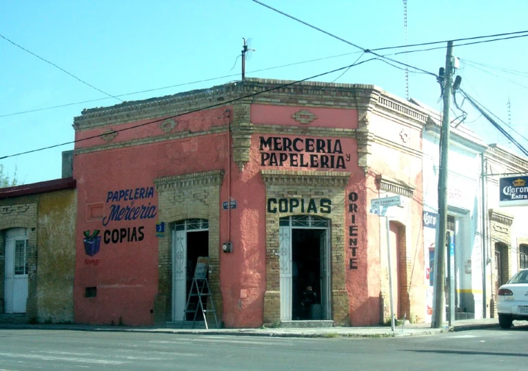 a small business on a corner has faded paint and sign work
