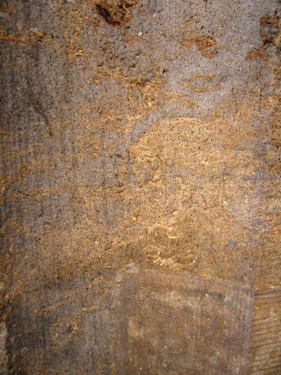 the background of brown and gray stone with scratches in it