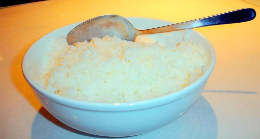 a spoon inside a bowl with rice on it