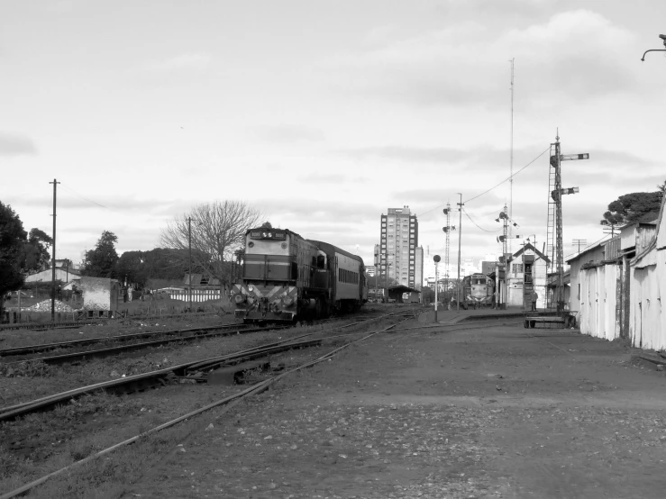 a railroad crossing through a rural town with buildings