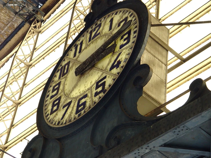 a large black and gold clock on the side of a building