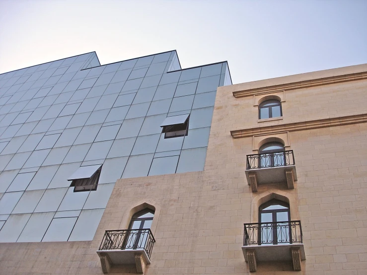 a brick and glass building that has balconies