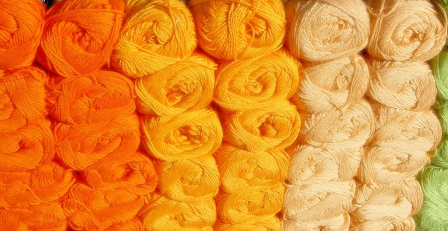 several different colors of yarn are lined up