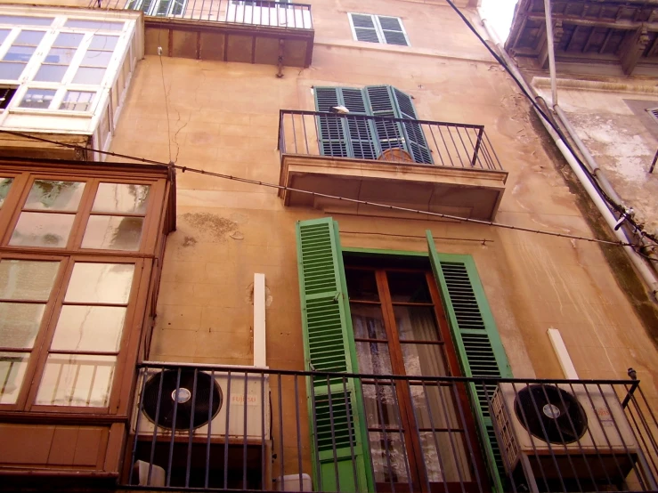 the balcony of an old style home that is painted red