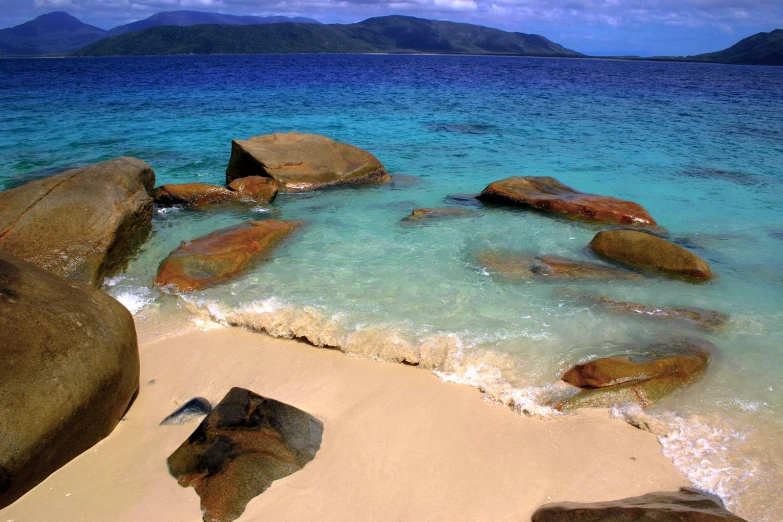 some water and some rocks on a beach