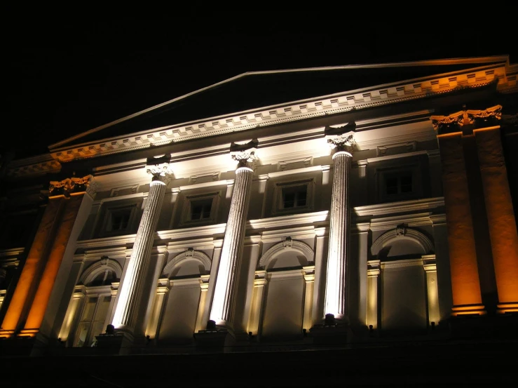 illuminated pillars stand out against the building