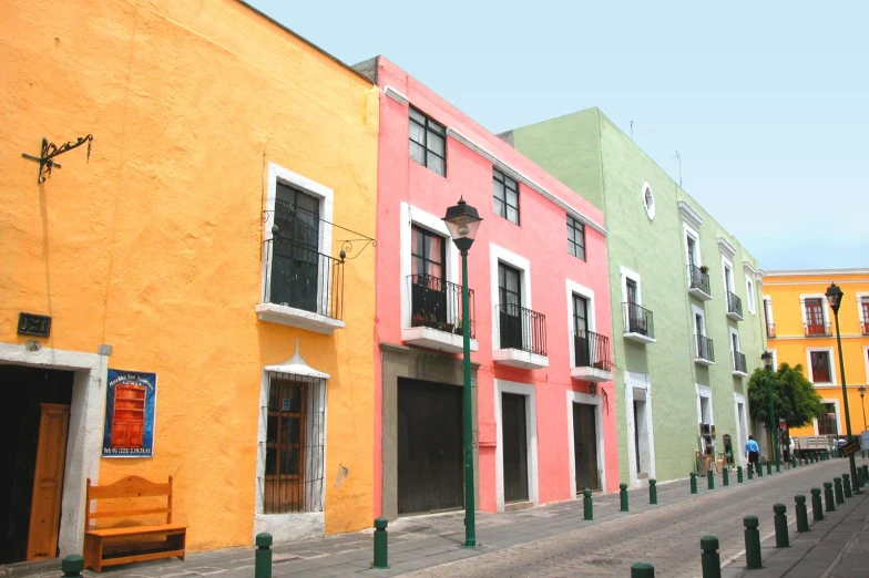 two rows of colorful buildings line this street in mexico