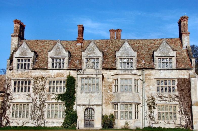 an old house with a lot of windows and lots of ivy