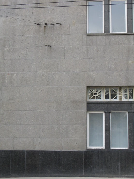 the exterior of an apartment building with broken windows