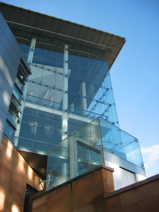 an office building with very tall windows in the daytime