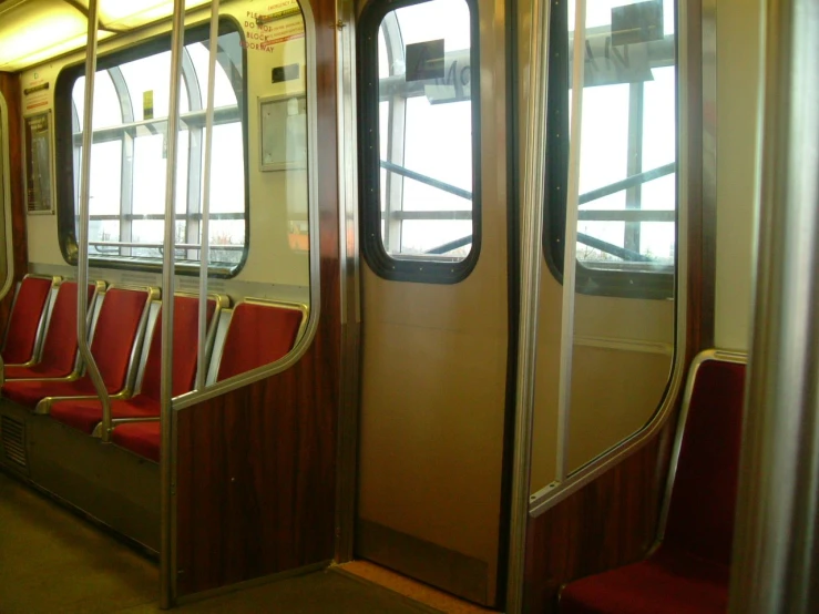 train seats with large windows are facing opposite direction